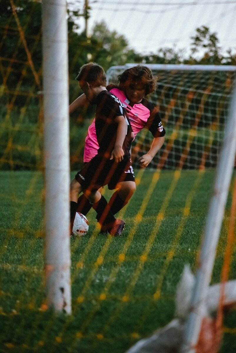 a couple of people playing football